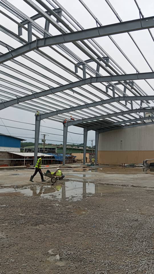 Charpente industrielle agroalimentaire 5 001 m² à Bonoua : bardage beige, structure métallique, couverture et montage en cours — vue 5